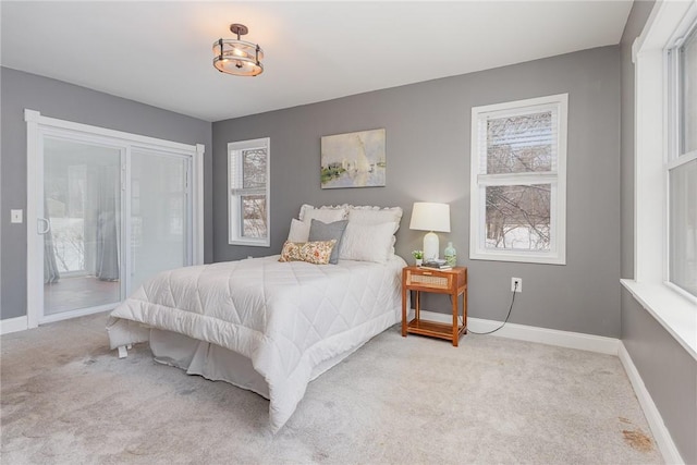 bedroom featuring multiple windows and light colored carpet