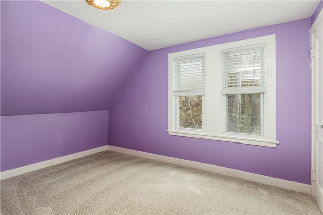 additional living space with lofted ceiling and carpet floors