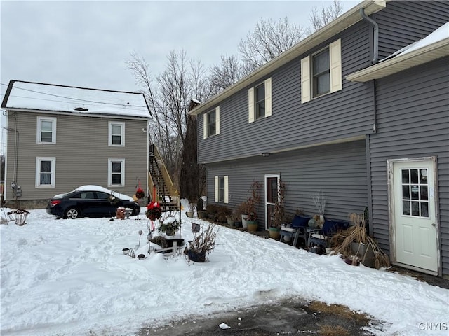 view of snow covered rear of property