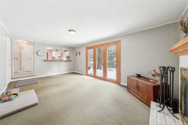 living room with crown molding, light colored carpet, and a fireplace