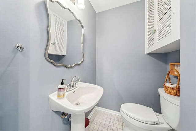 bathroom featuring tile patterned flooring, sink, and toilet