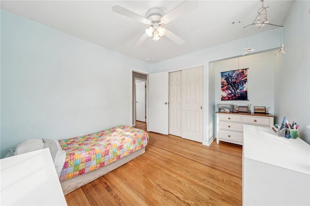 bedroom with a closet, ceiling fan, and light wood-type flooring