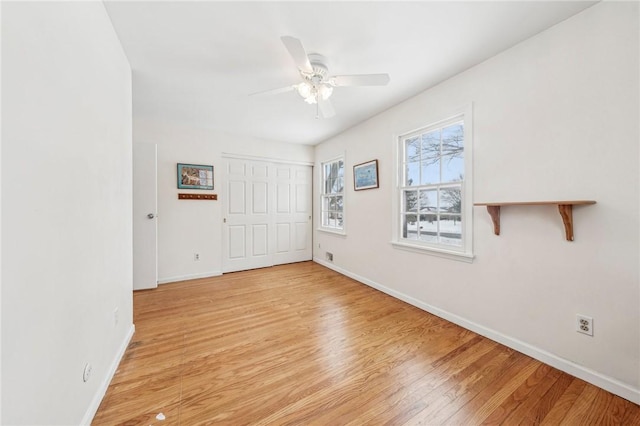 unfurnished room featuring ceiling fan and light wood-type flooring