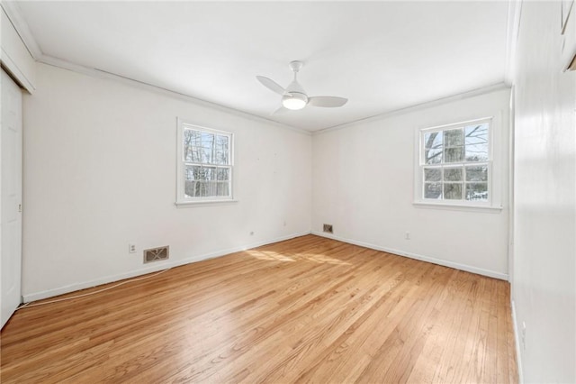 unfurnished room featuring light hardwood / wood-style flooring, crown molding, plenty of natural light, and ceiling fan