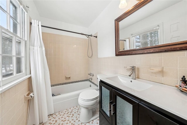 full bathroom featuring vanity, tile walls, shower / tub combo, and toilet