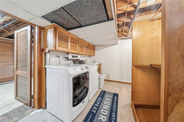 laundry area featuring cabinets and separate washer and dryer