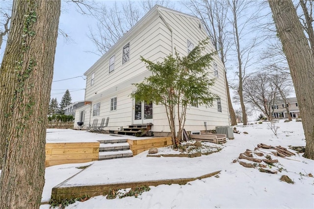 view of snow covered exterior with central AC