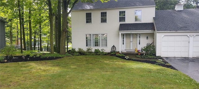 view of front of house with a garage and a front lawn