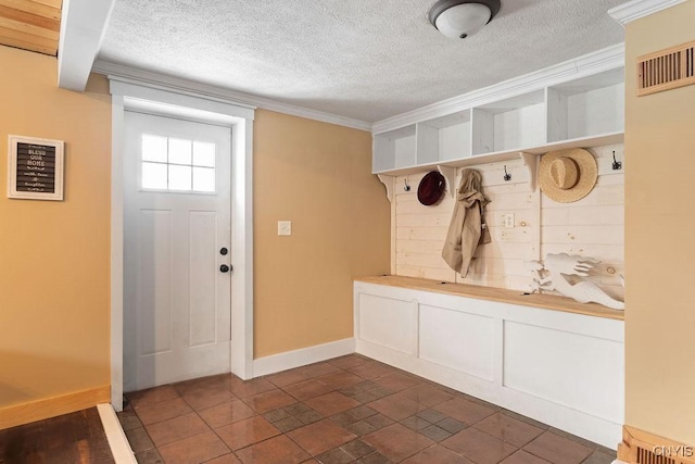 mudroom with crown molding and a textured ceiling