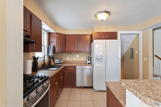 kitchen featuring light tile patterned flooring, appliances with stainless steel finishes, and sink