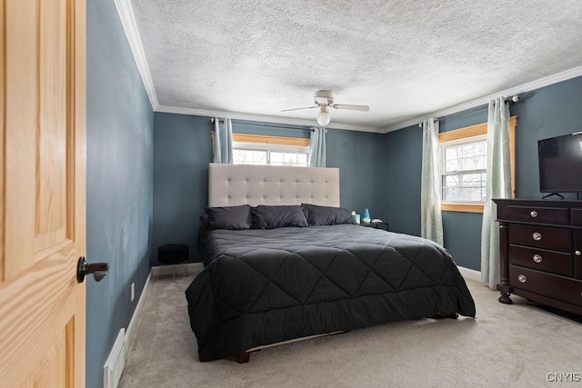 carpeted bedroom featuring multiple windows, a textured ceiling, ornamental molding, and ceiling fan