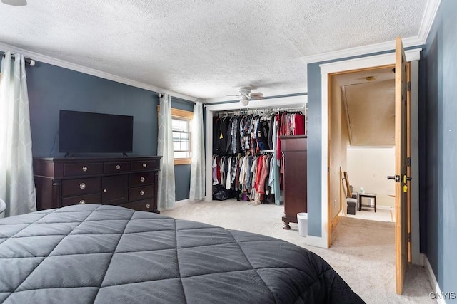 carpeted bedroom with crown molding, a textured ceiling, and a closet