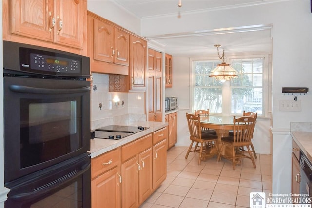 kitchen with light tile patterned flooring, black appliances, hanging light fixtures, ornamental molding, and backsplash