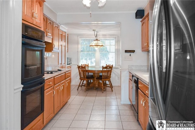 kitchen with hanging light fixtures, crown molding, black appliances, and light tile patterned floors