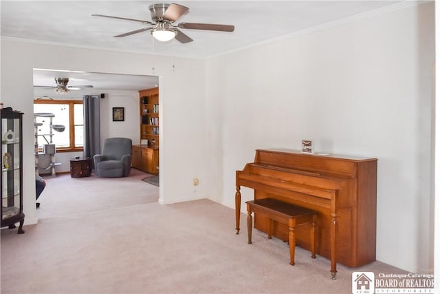 misc room featuring crown molding, ceiling fan, and light carpet