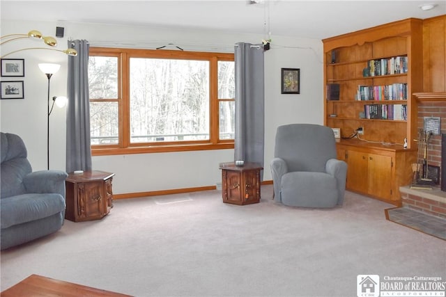 living area with a fireplace, light carpet, and a wealth of natural light