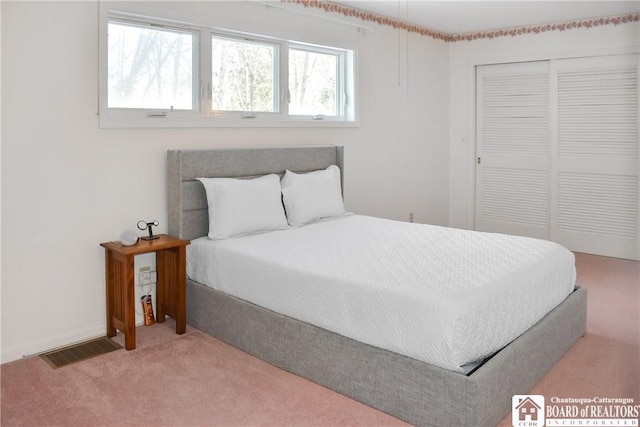 bedroom with carpet and a closet