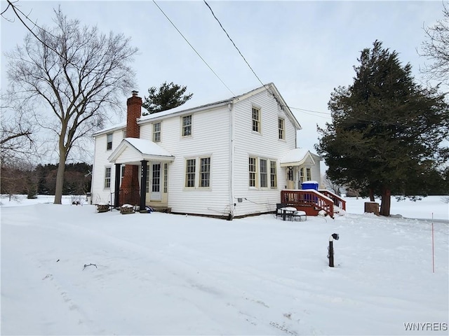 snow covered property with a deck