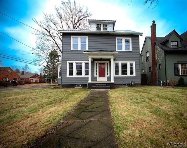 view of front facade with a front yard and central air condition unit