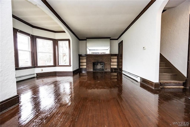 unfurnished living room featuring hardwood / wood-style flooring, a fireplace, ornamental molding, and baseboard heating