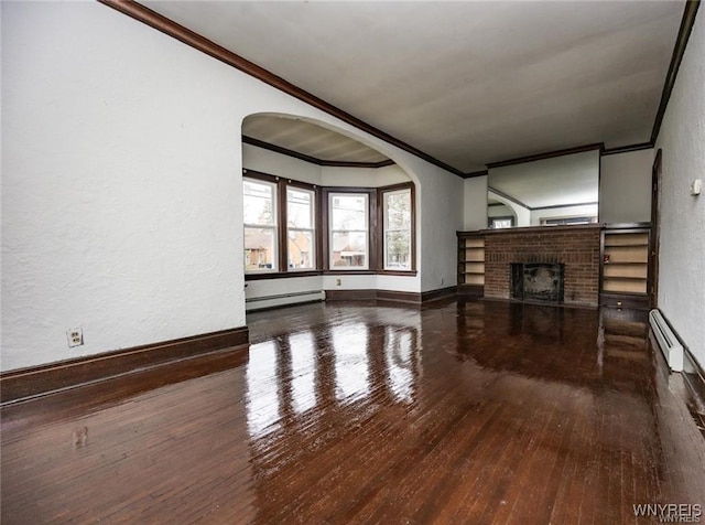 unfurnished living room with crown molding, a fireplace, hardwood / wood-style flooring, and a baseboard heating unit