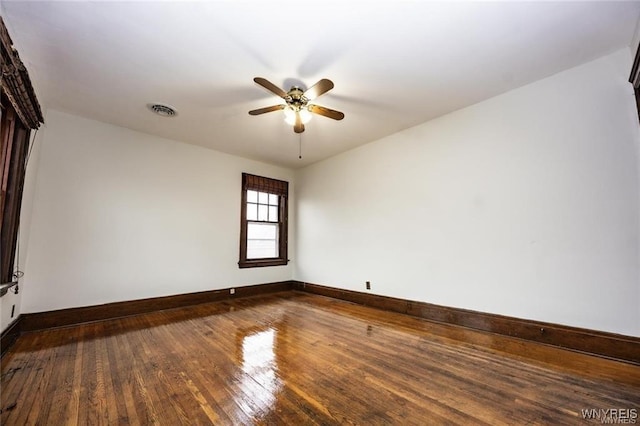 spare room with hardwood / wood-style flooring and ceiling fan