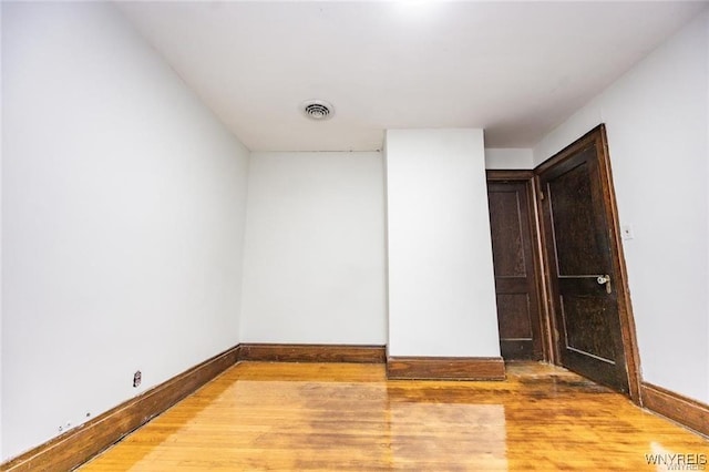 unfurnished room featuring hardwood / wood-style flooring