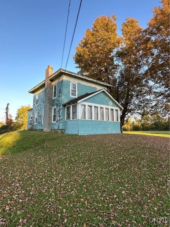 view of property exterior featuring a lawn