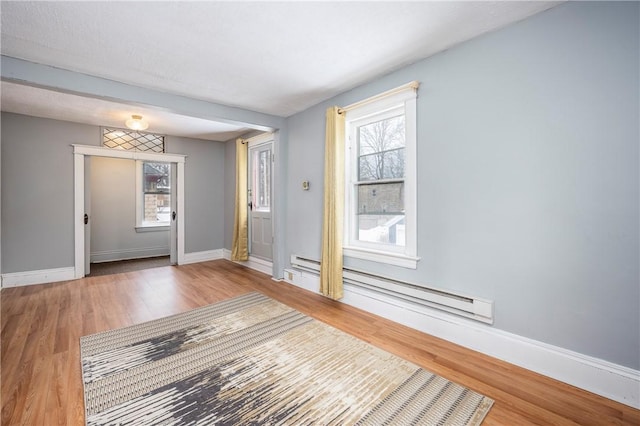 entryway featuring hardwood / wood-style floors and baseboard heating