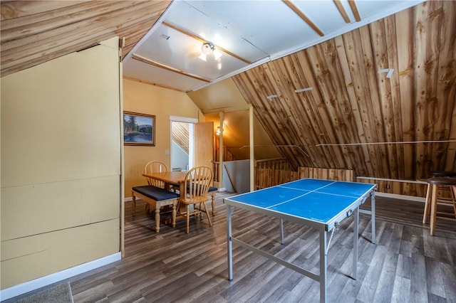 rec room with wood-type flooring, lofted ceiling, and wood walls