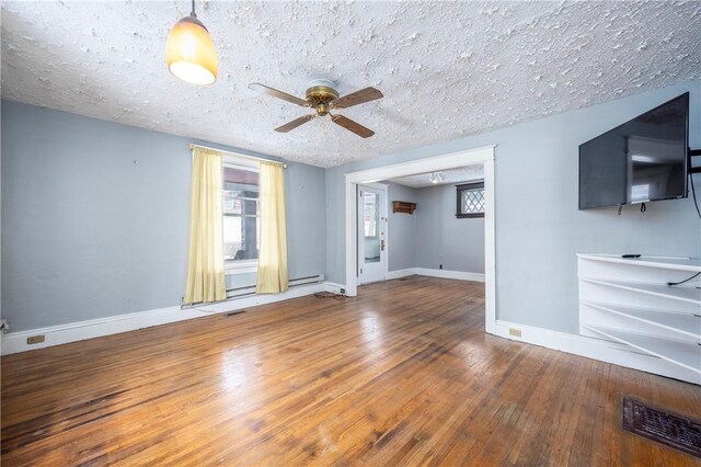 unfurnished living room featuring hardwood / wood-style flooring, ceiling fan, and a textured ceiling