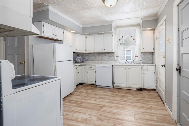 kitchen with white cabinetry, sink, backsplash, and white appliances