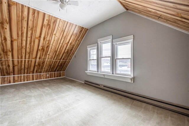 additional living space with carpet, a baseboard heating unit, lofted ceiling, and ceiling fan