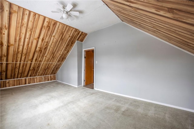 additional living space with vaulted ceiling, carpet flooring, and ceiling fan