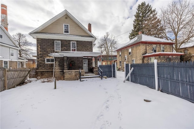 snow covered property featuring a porch