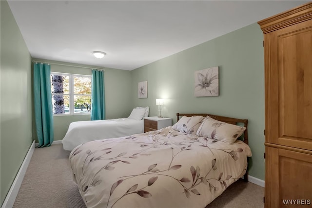 bedroom featuring light carpet