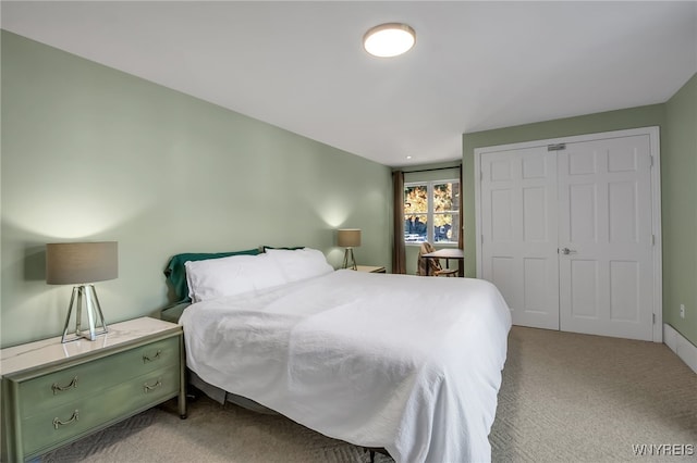 bedroom with light colored carpet and a closet