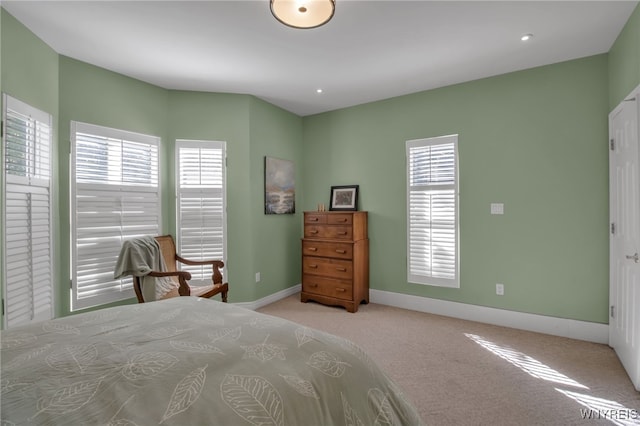 carpeted bedroom with multiple windows