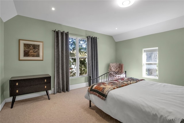 carpeted bedroom featuring lofted ceiling