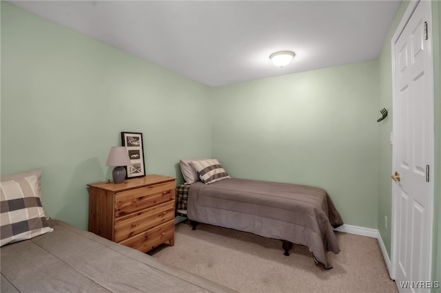 bedroom featuring light colored carpet