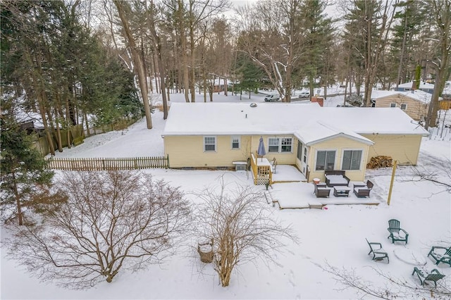 view of snow covered rear of property