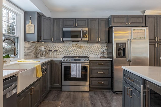 kitchen with wine cooler, stainless steel appliances, dark hardwood / wood-style flooring, and backsplash