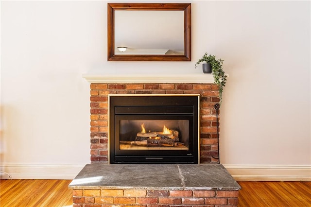 details featuring wood-type flooring and a brick fireplace