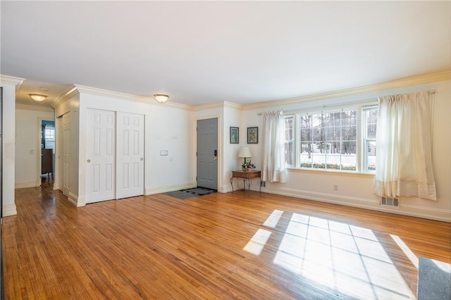 unfurnished room with crown molding and hardwood / wood-style floors