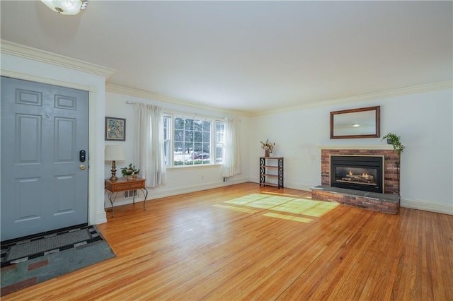 living room with ornamental molding, a fireplace, and light hardwood / wood-style flooring