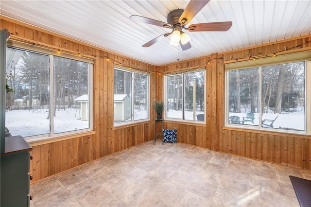 unfurnished sunroom with wooden ceiling and ceiling fan