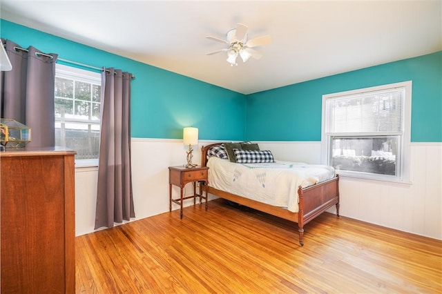 bedroom with light hardwood / wood-style flooring and ceiling fan