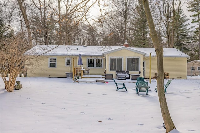 view of snow covered rear of property