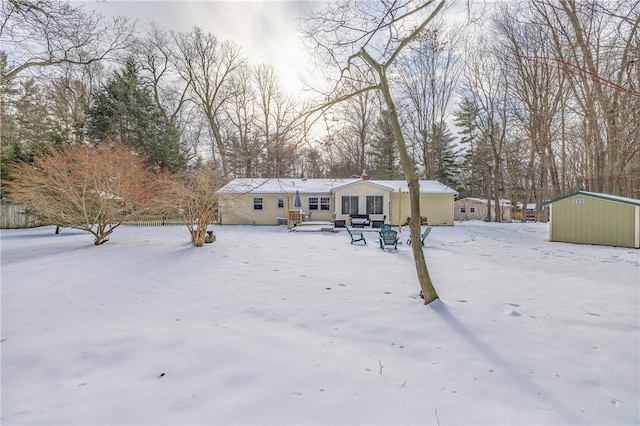 view of front of home with a shed