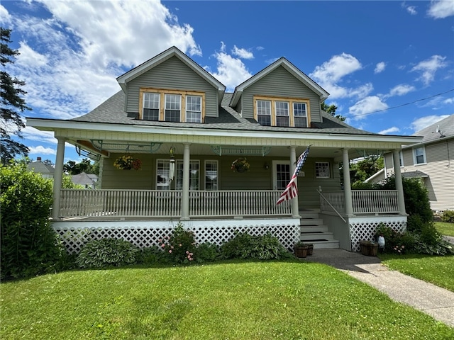 view of front of house with a front yard and covered porch